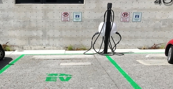 Electric car charging station and parking spaces